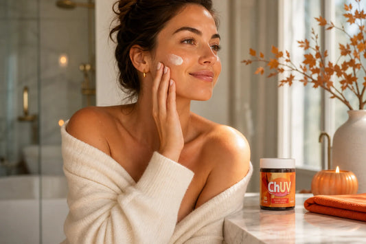 Woman with a natural summer glow from ChUV tanning gummies practicing fall skin care in a sunlit bathroom