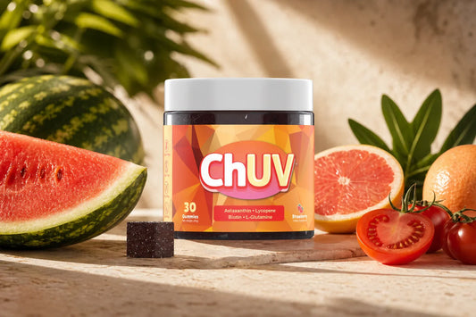 ChUV tanning gummy jar surrounded by foods that change skin color including tomatoes, watermelon, and grapefruit on a sun-warmed surface