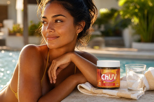 A woman with a deep, natural sun kissed glow relaxing poolside next to a bottle of ChUV Tanning Gummies, golden hour light