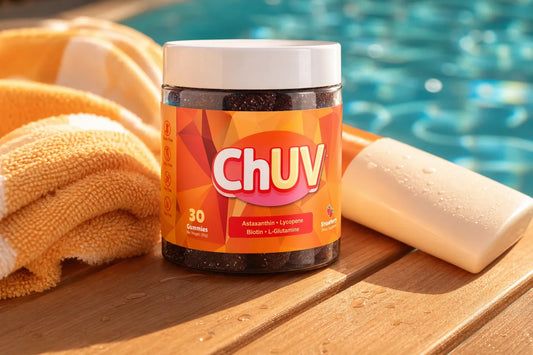 Bottle of ChUV tanning gummies on a poolside table beside a chlorinated swimming pool