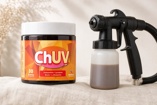 ChUV tanning gummies jar beside a professional spray tan gun on a marble surface, editorial beauty flat-lay, warm natural side lighting, 16:9