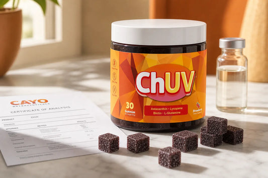 Third-party testing decoded: COA lab documents and ChUV tanning gummies arranged on a clean white marble surface with warm natural lighting